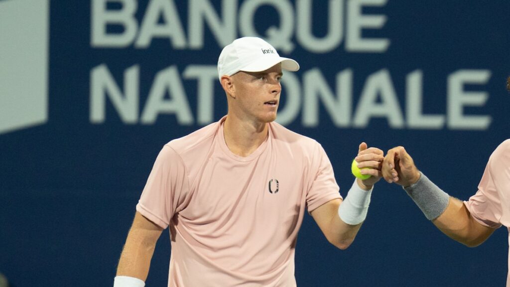 Cleeve Harper fists bumps his doubles partner.