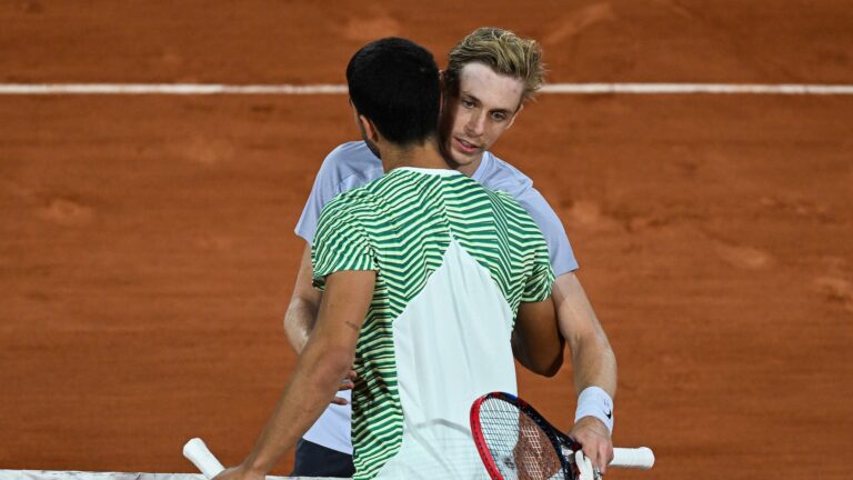 Denis Shapovalov embraces Carlos Alcaraz (back to camera) at Roland-Garros.