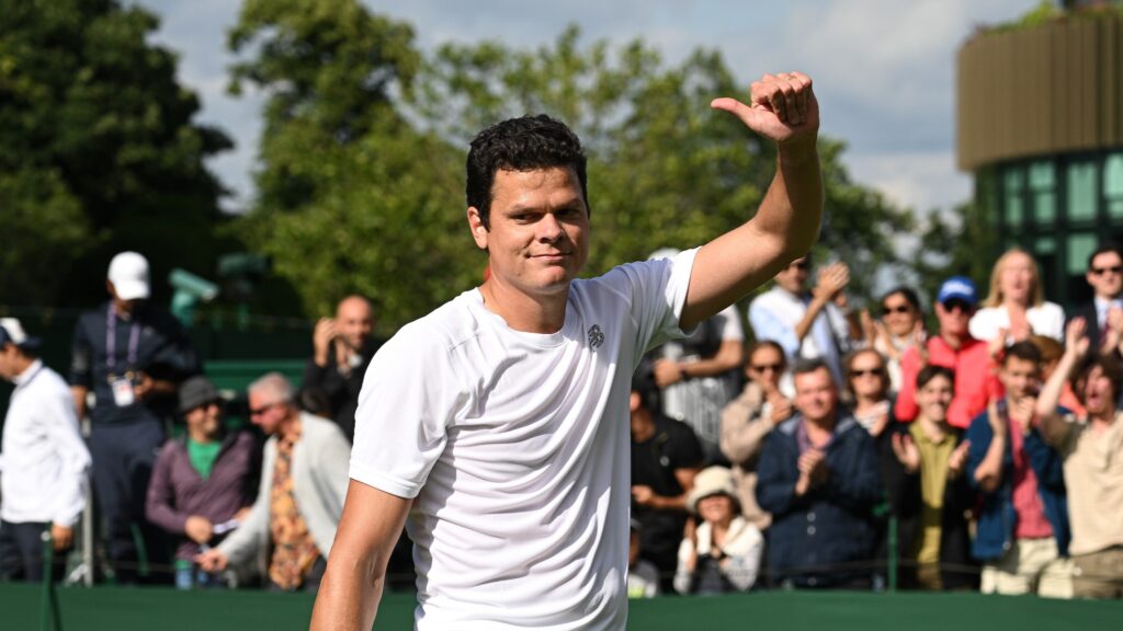 Milos Raonic gives a thumbs up to the crowd on the grass courts of Wimbledon.