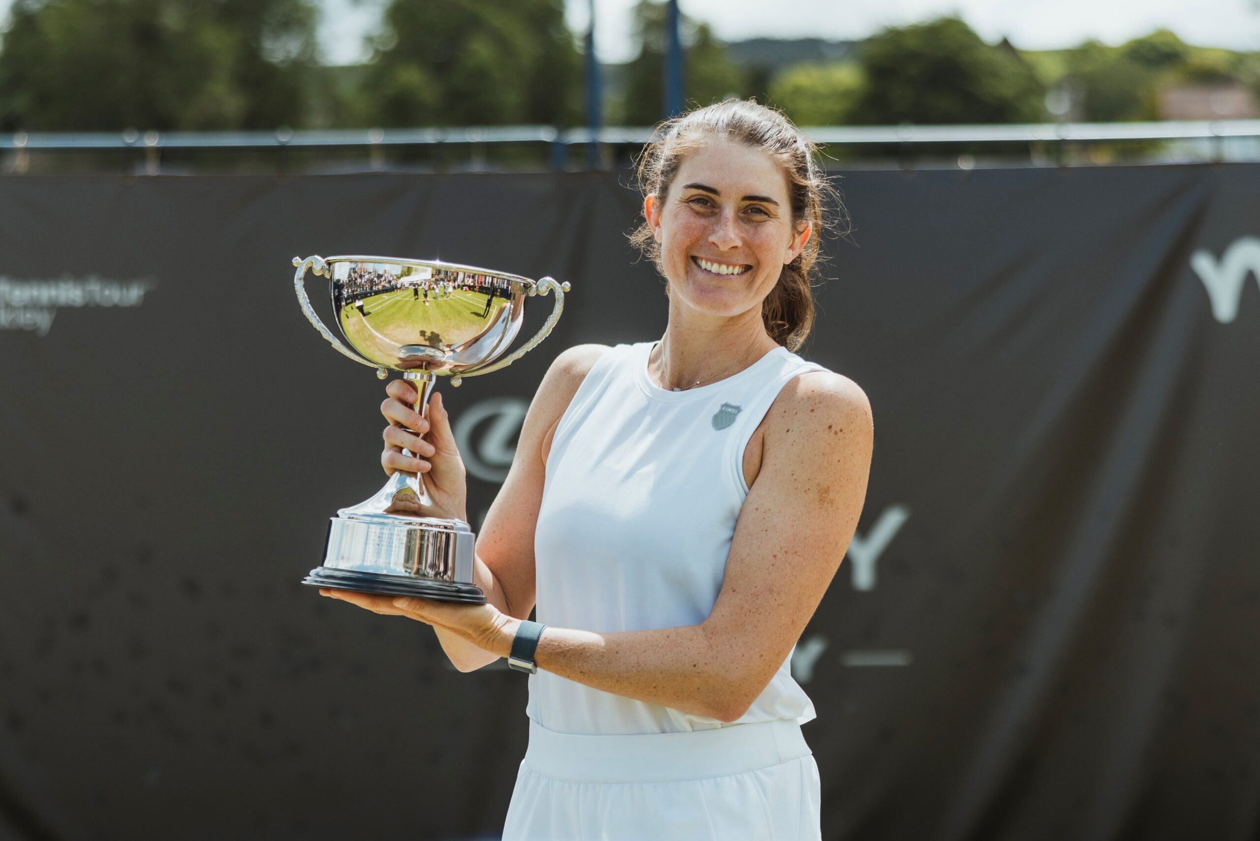 Rebecca Marino holds up the Ilkley trophy, her first title on grass. She is playing qualifying at Wimbledon this week.