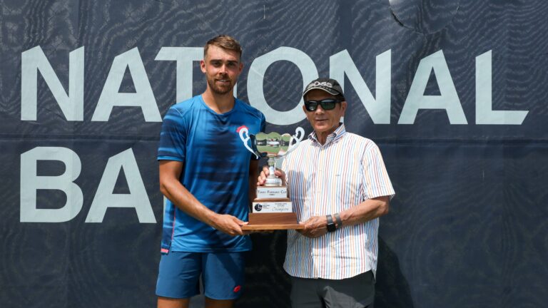Benjamin Bonzi (right) holds up the trophy at the Winnipeg Challenger.