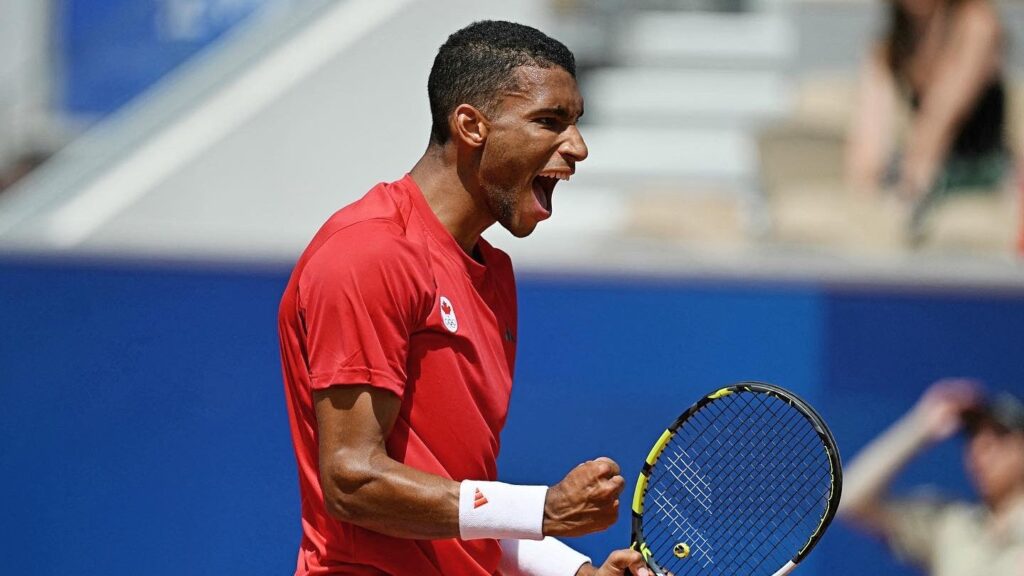 Felix Auger-Aliassime pumps his fist and yells. He is one of fives Canadians who entered the Olympics.