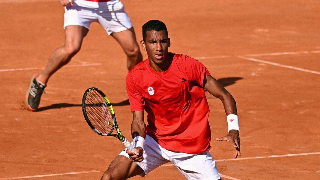 Felix Auger-Aliassime hits a forehand volley. He won on Tuesday, but Leylah Fernandez was eliminated at the Olympics.