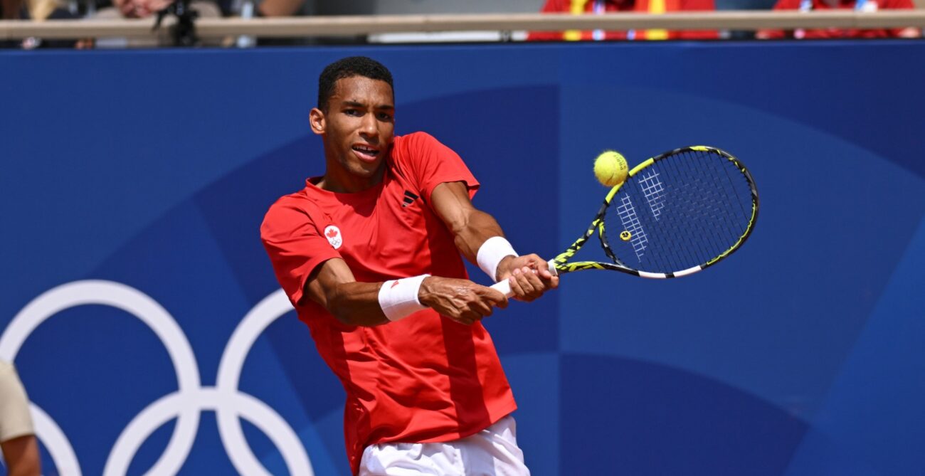 Felix Auger-Aliassime hits a backhand during his semifinal loss to Carlos Alcaraz at the Olympics.