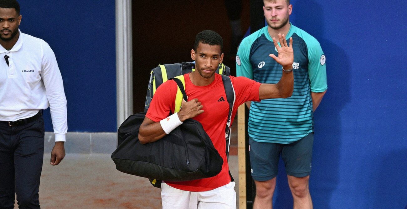 Felix Auger-Aliassime waves to the crowd as he walks on court at the Olympics. He lost in the bronze-medal match to Lorenzo Musetti.