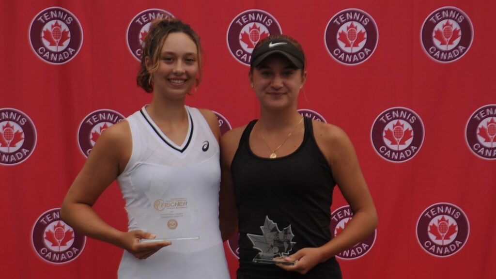 Two Canadian junior players hold their trophies and smile after their final on home soil at the U18s.