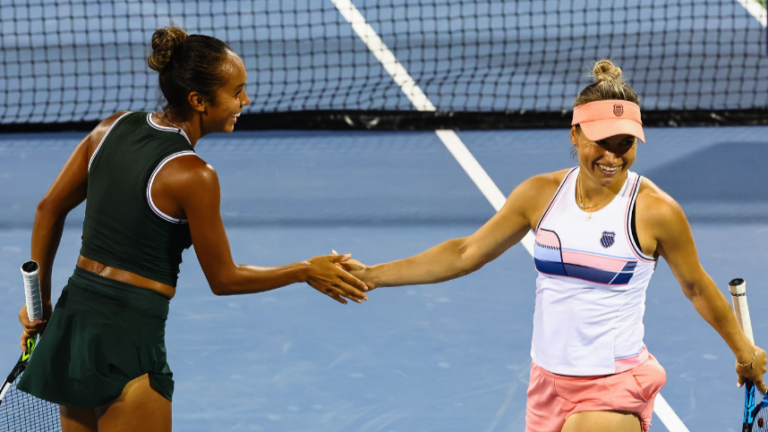 Leylah Fernandez (left) high-fives Yulia Putintseva during a doubles match in Cincinnati.