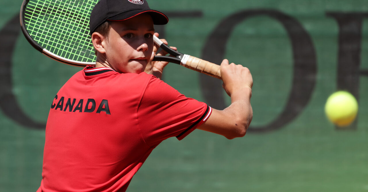 Callum MacKinnon backhands a ball at the ITF World Junior Tennis Finals