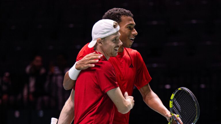 Denis Shapovalov (foreground) and Felix Auger-Aliassime embrace. Canada beat Britain at the Davis Cup Finals on Sunday.