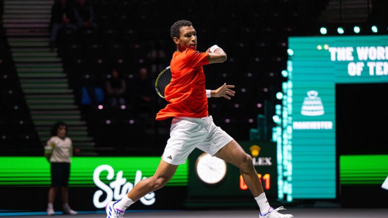 Felix Auger-Aliassime leaps into the air as he follows through on a forehand. His two wins helped Canada get revenge on Finland at the Davis Cup.