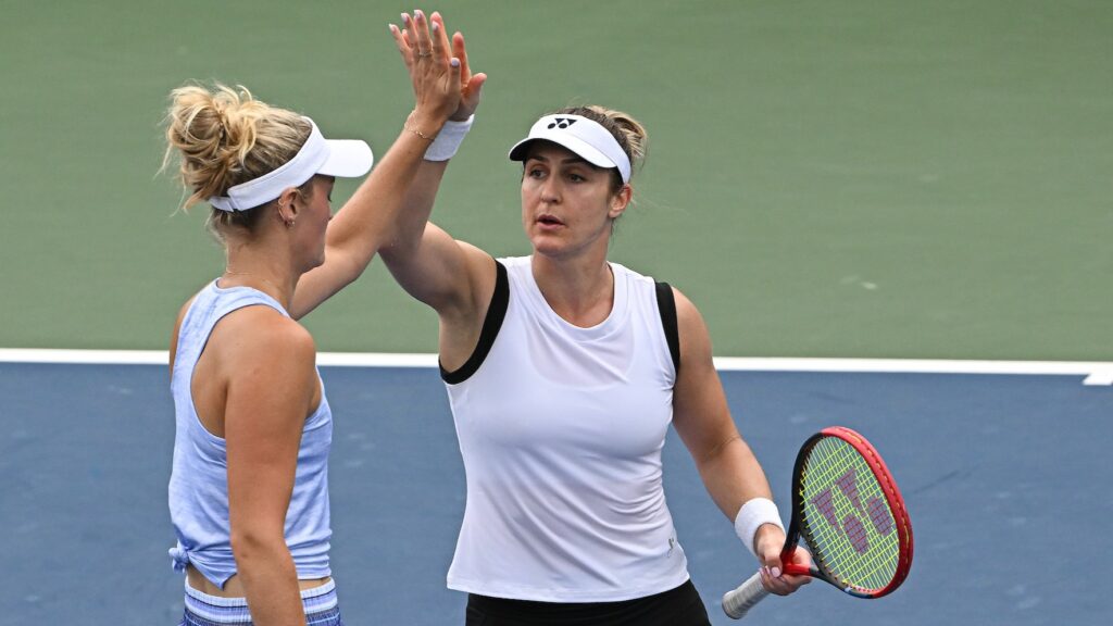 Gabriela Dabrowski high fives Erin Routliffe (back to camera) at the US Open.