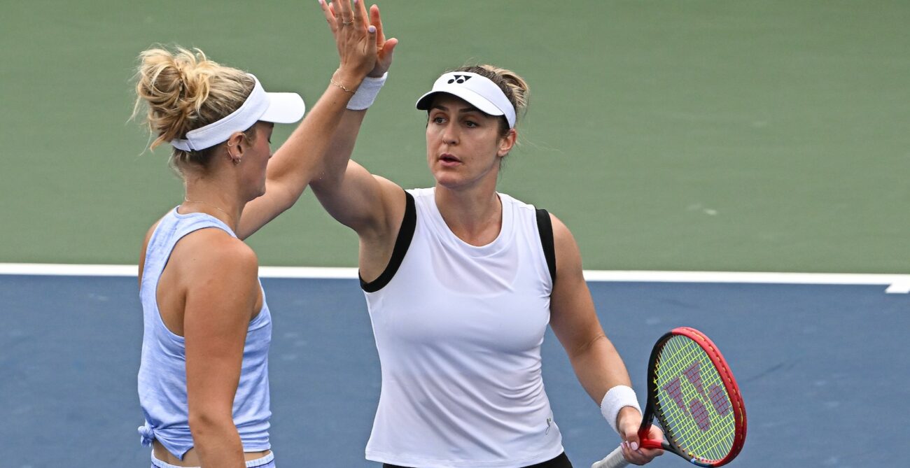 Gabriela Dabrowski high fives Erin Routliffe (back to camera) at the US Open.