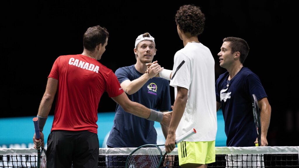 From left to right: Vasek Pospisil (back turned), Denis Shapovalov, Gabriel Diallo (back turned), and Alexis Galarneau of Team Canada shakes hands during a practice at the Davis Cup in Manchester.