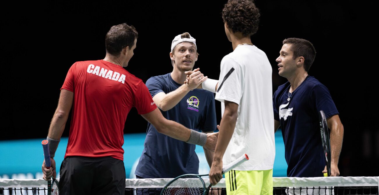 From left to right: Vasek Pospisil (back turned), Denis Shapovalov, Gabriel Diallo (back turned), and Alexis Galarneau of Team Canada shakes hands during a practice at the Davis Cup in Manchester.