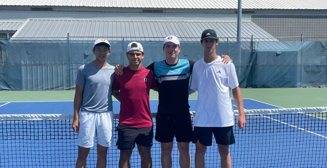 The four U18 boys doubles finalists pose at the the net at the U18 Fischer Outdoor Nationals, one of four Canadian junior championships over the last month.