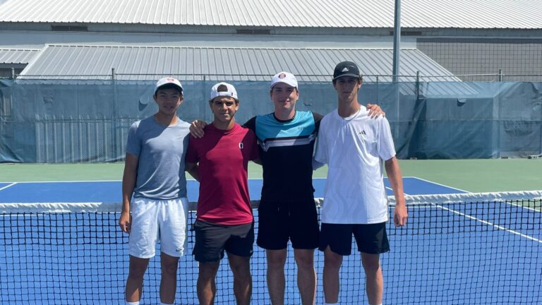 The four U18 boys doubles finalists pose at the the net at the U18 Fischer Outdoor Nationals, one of four Canadian junior championships over the last month.