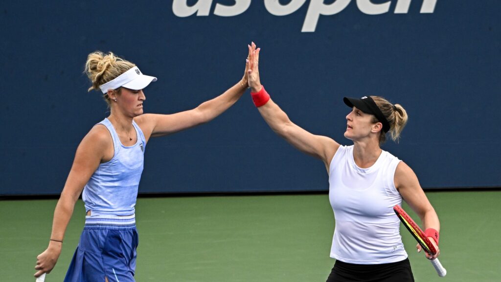 Gabriela Dabrowski (right) and Erin Routliffe (left) high-five. They qualified for the WTA Finals on Monday,