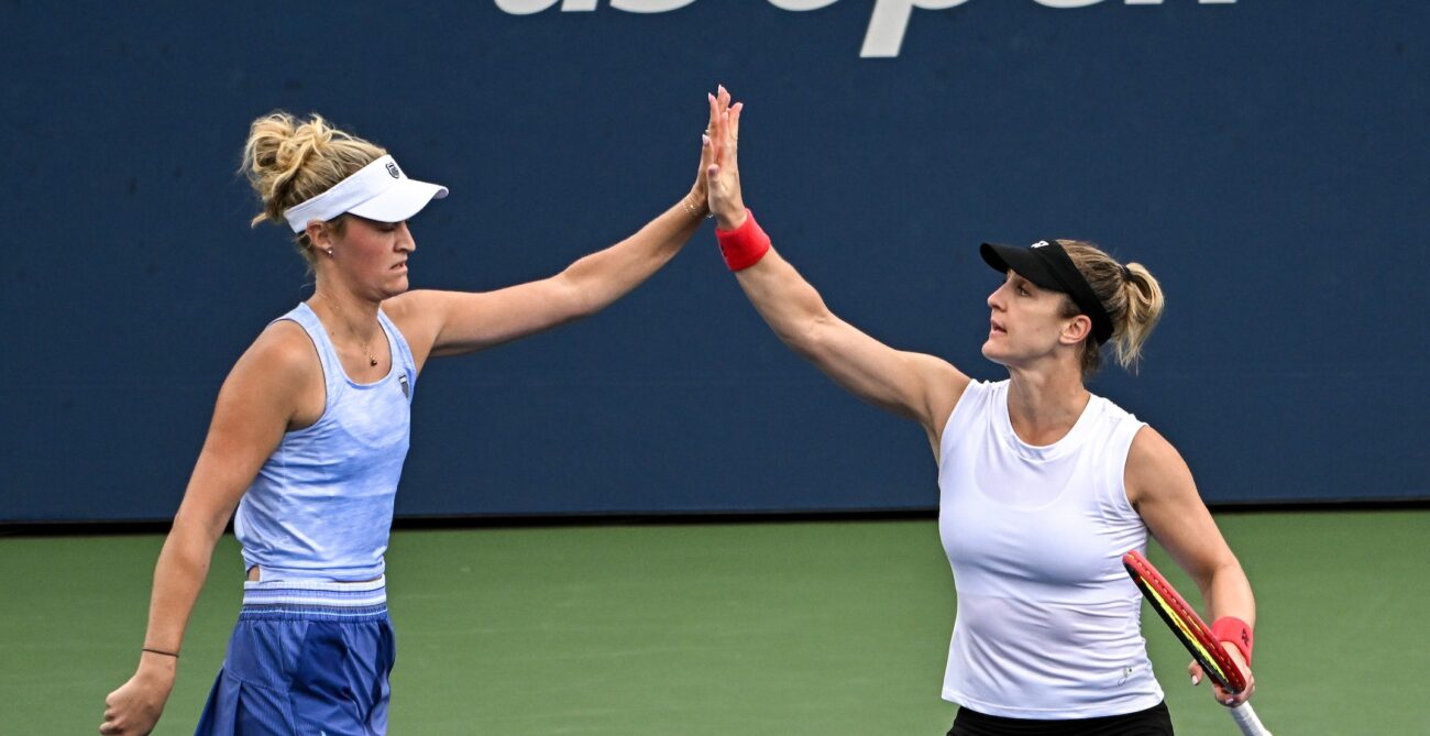 Gabriela Dabrowski (right) and Erin Routliffe (left) high-five. They qualified for the WTA Finals on Monday,