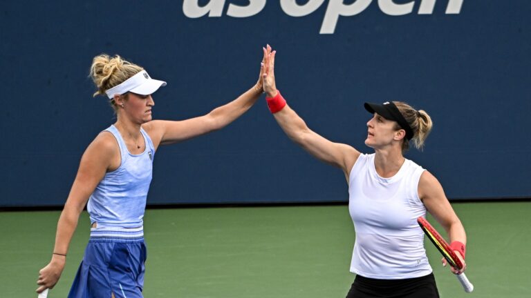 Gabriela Dabrowski (right) and Erin Routliffe (left) high-five. They qualified for the WTA Finals on Monday,