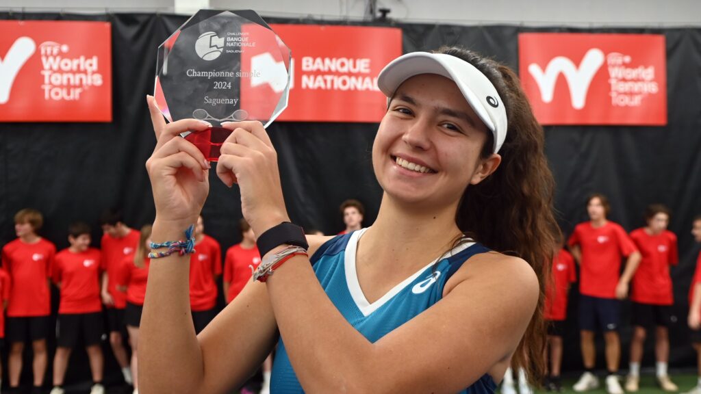 Petra Marcinko holds up her champions trophy in Saguenay.