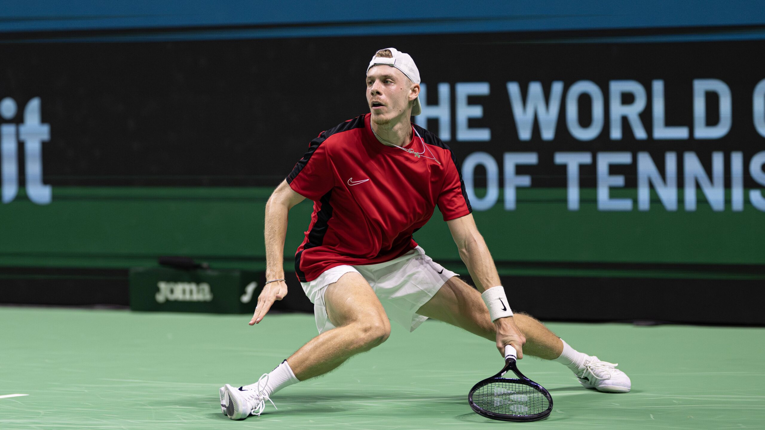 Denis Shapovalov slides after hitting a shot during Canada's Davis Cup loss to Germany.