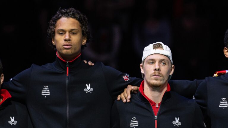 Gabriel Diallo (left) and Denis Shapovalov (right) stand in line before a match at the Davis Cup in Manchester.