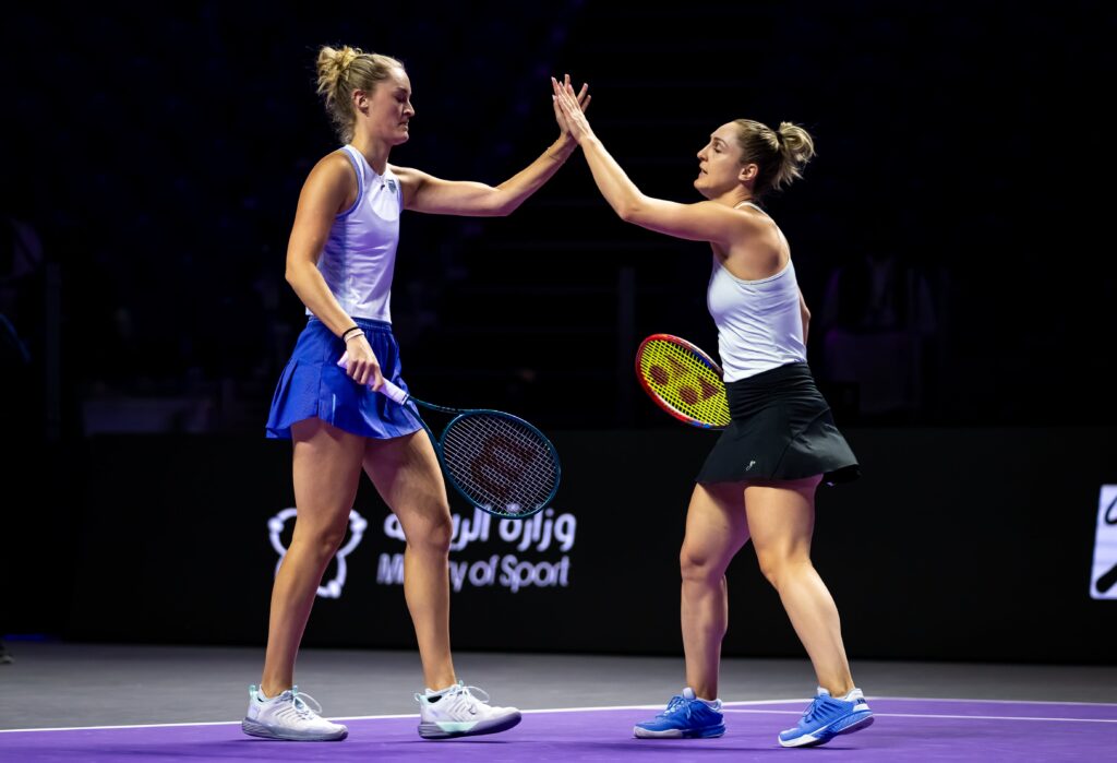 Gabriela Dabrowski and Erin Routliffe high five at 2024 WTA Finals