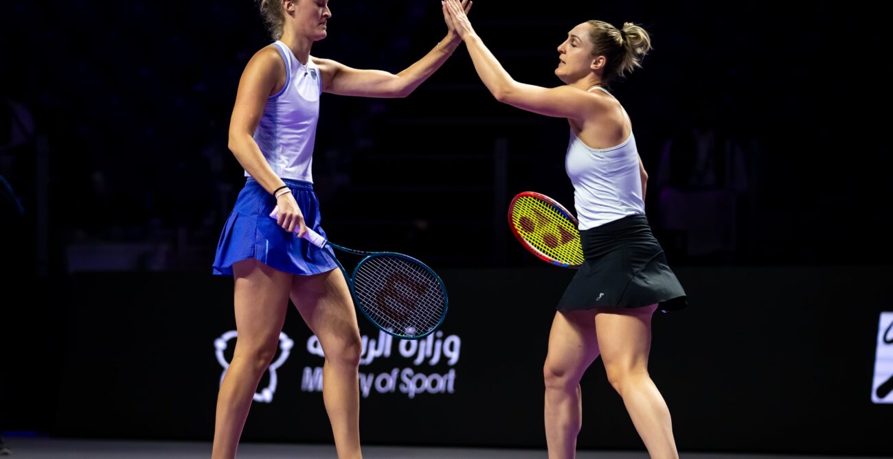 Gabriela Dabrowski and Erin Routliffe high five at 2024 WTA Finals