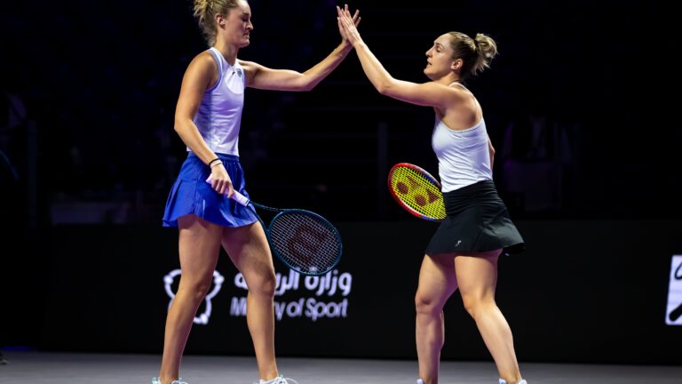 Gabriela Dabrowski and Erin Routliffe high five at 2024 WTA Finals