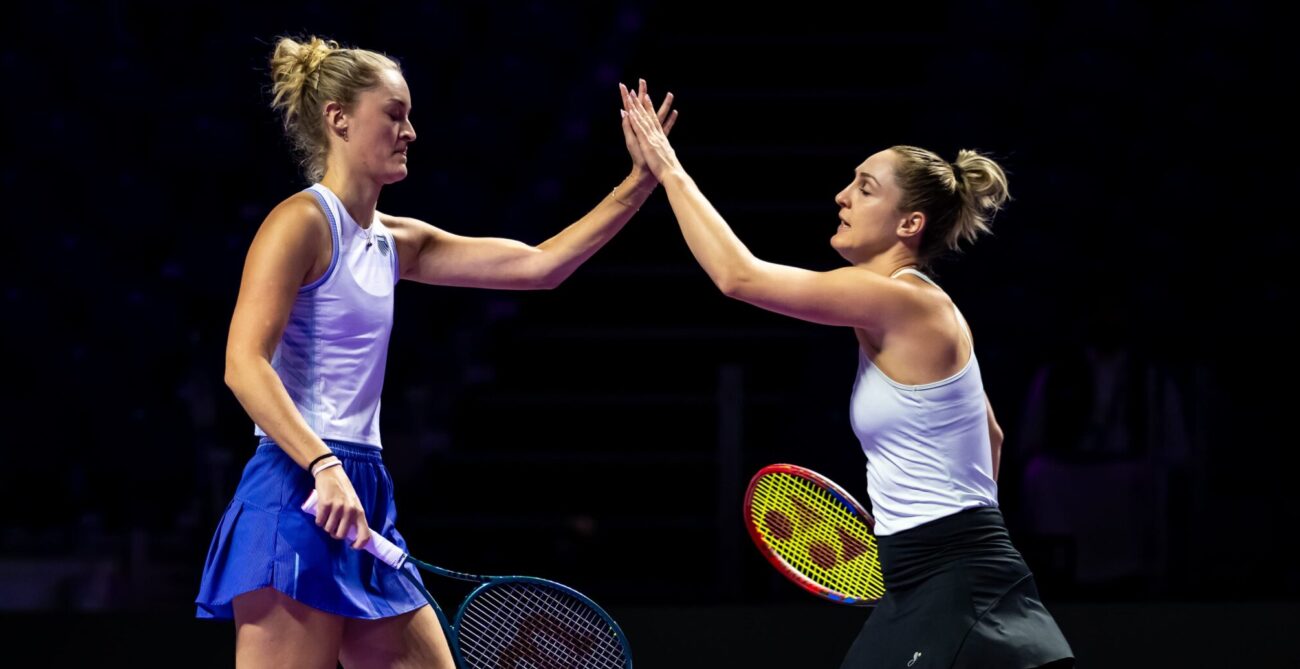 Gabriela Dabrowski and Erin Routliffe high five at 2024 WTA Finals