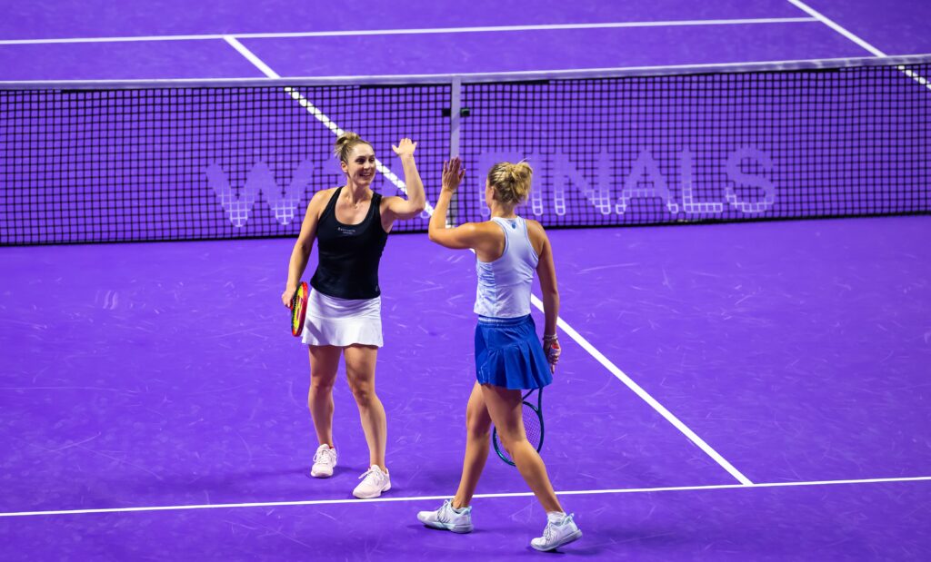 Gabriela Dabrowski and Erin Routliffe high five at 2024 WTA Finals