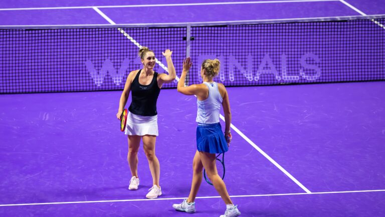 Gabriela Dabrowski and Erin Routliffe high five at 2024 WTA Finals