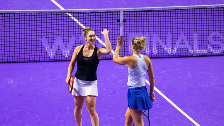 Gabriela Dabrowski and Erin Routliffe high five at 2024 WTA Finals