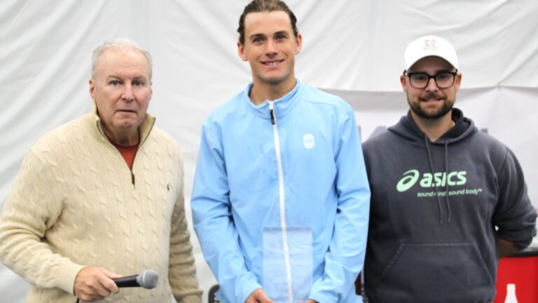 Liam Draxl (centre) holds his trophy after beating Alexis Galarneau in the final of the ITF event in Saint-Augustin.