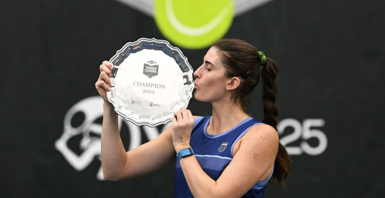 Rebecca Marino kisses a trophy. She was one of five Canadians to win titles in what was the best week for Canadian tennis in 2024.