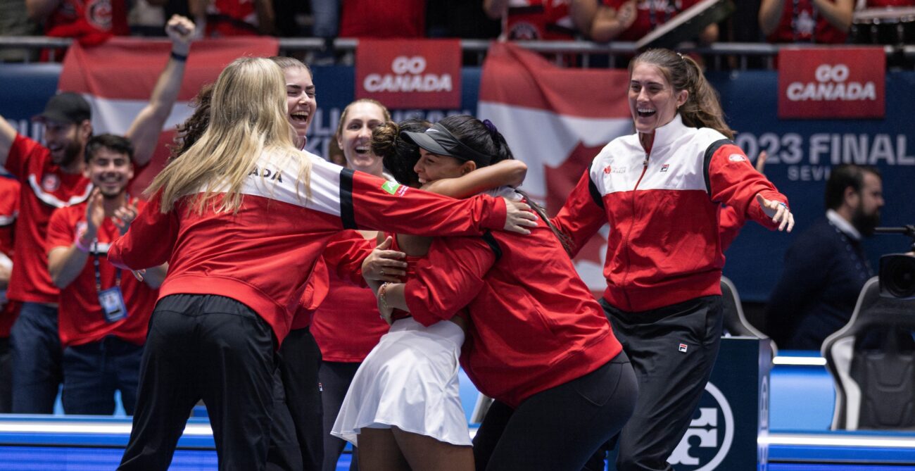 From left to right: Eugenie Bouchard (back to camera), Marina Stakusic, Gabriela Dabrowski and Rebecca Marino celebrate while Leylah Annie Fernandez and Heidi El Tabakh hug in the foreground after winning the Billie Jean King Cup.