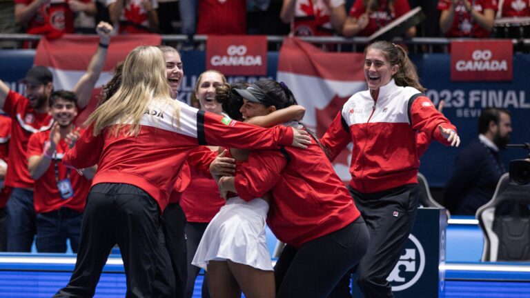 From left to right: Eugenie Bouchard (back to camera), Marina Stakusic, Gabriela Dabrowski and Rebecca Marino celebrate while Leylah Annie Fernandez and Heidi El Tabakh hug in the foreground after winning the Billie Jean King Cup.