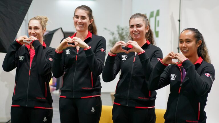 Team Canada (from left to right, Gabriela Dabrowski, Rebecca Marino, Marina Stakusic, Leylah Annie Fernandez) all make heart shapes with their hands.