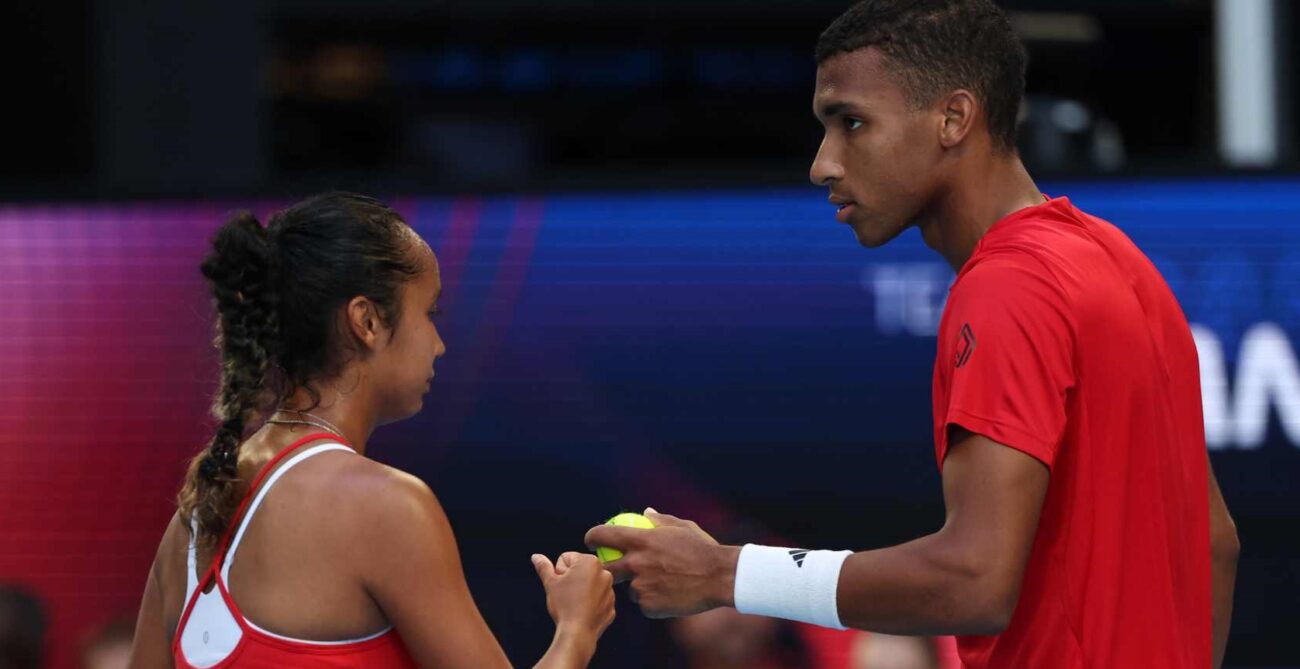 Felix Auger-Aliassime (right) and Leylah Annie Fernandez (left, side to camera) bump fists while representing Canada at the United Cup.