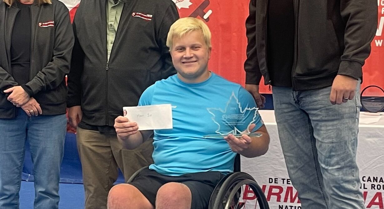 Thomas Venos holds up a trophy at the Birmingham Nationals, Canada's wheelchair tennis national championships.