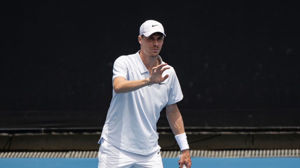 Denis Shapovalov raises his hand to catch a ball. He has withdrawn from Canada's Davis Cup tie with Hungary.