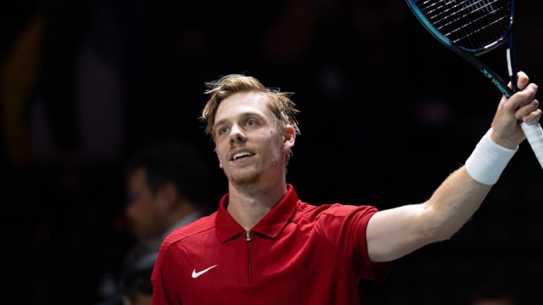 Denis Shapovalov raise his racket over his head in celebration. He will lead Team Canada at the Davis Cup in Montreal.