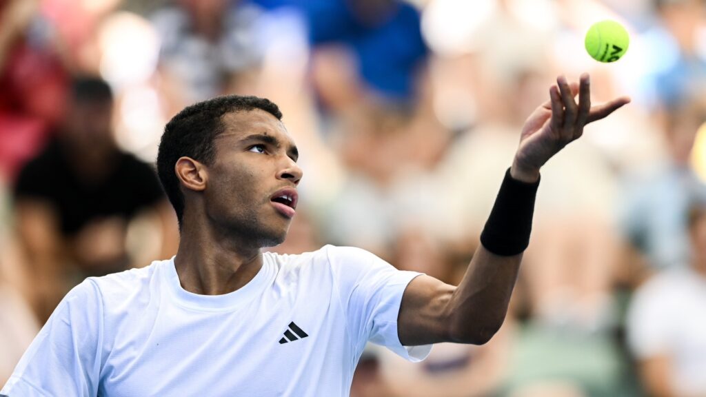 Felix Auger-Aliassime tosses a ball up to serve. He beat Tommy Paul on Friday in Adelaide.