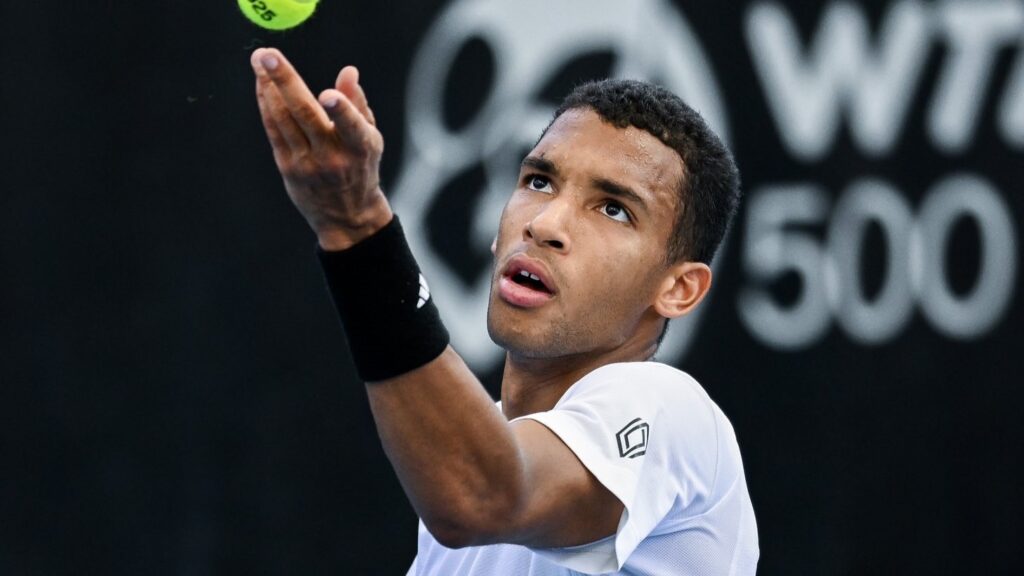 Felix Auger-Aliassime tosses a ball up to serve in Adelaide. He beat Marcos Giron in the quarter-finals on Thursday.