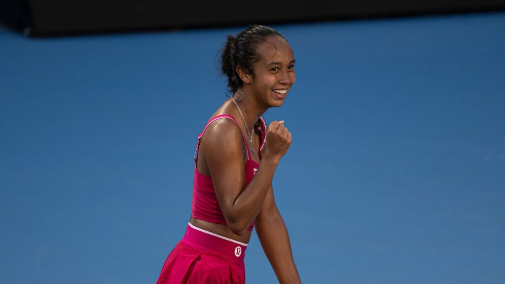 Leylah Fernandez pumps her fist and smiles. She and Felix Auger-Aliassime both advanced on Wednesday at the Australian Open.