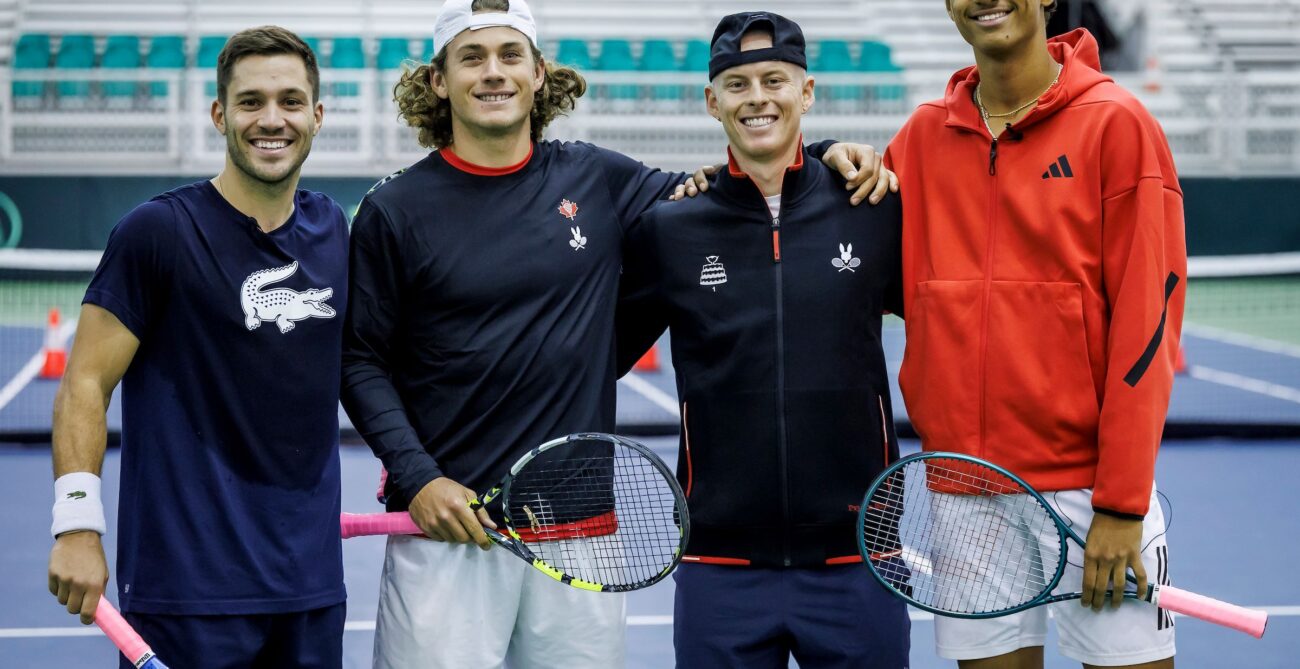 From left to right: Alexis Galarneau, Liam Draxl, Cleeve Harper, and Gabriel Diallo stand together on court at the Davis Cup.