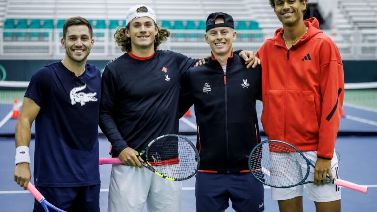 From left to right: Alexis Galarneau, Liam Draxl, Cleeve Harper, and Gabriel Diallo stand together on court at the Davis Cup.