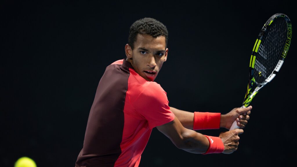 Felix Auger-Aliassime winds up to hit a backhand. Rublev Doha