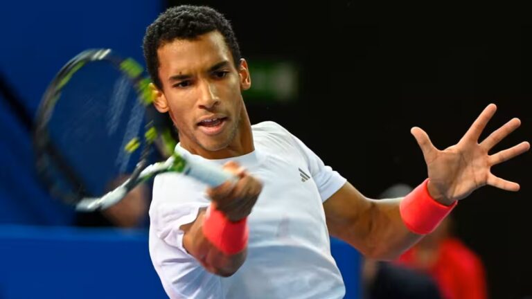 Felix Auger-Aliassime hits a forehand. He advanced to the Doha semis when Daniil Medvedev retired.