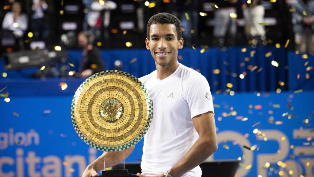 Felix Auger-Aliassime holds up the trophy in Montpellier, his second of 2025.